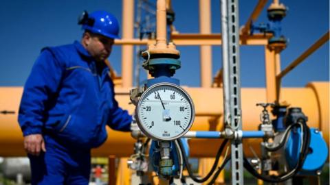 A employee works near gas pipes at the gas compressor station of Bulgartransgaz in Ihtiman, on 5 May 2022, a week after the halt of Russian gas supply to Bulgaria