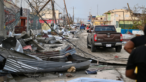 A car drives through the a destroyed neighbourhood following the passage of Hurricane Melissa, in Black River, Jamaica
