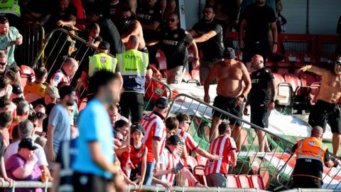 CSKA Sofia fans rush a barrier at the Brandywell