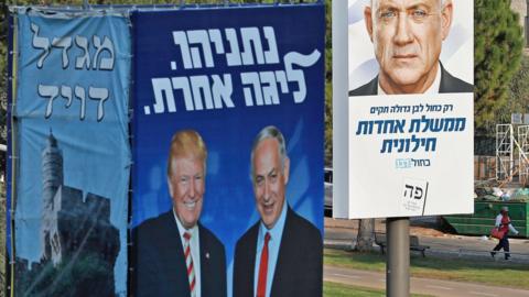 Israeli election billboards in Jerusalem, showing US President Donald Trump (L) shaking hands with Prime Minister Benjamin Netanyahu (2nd L), and Benny Gantz (R)