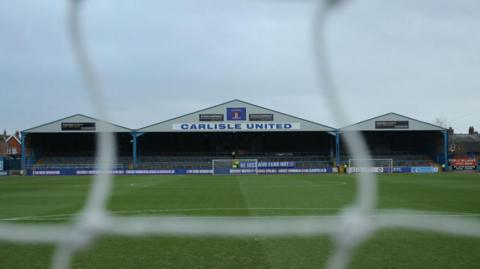 A view of the Warwick Road end at Carlisle's Brunton Park from behind the goal at the other end