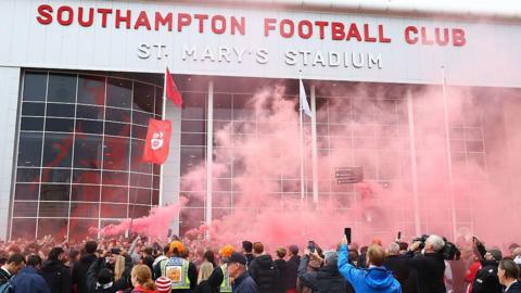 A general view of football fans holding smoke flares outside the stadium prior to the Sky Bet Championship match between Southampton and Portsmouth at St Mary's Stadium