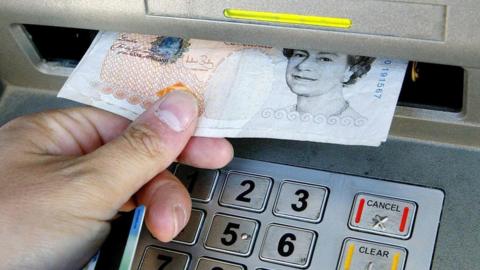 Man withdrawing £10 from cash machine