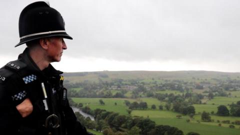 PC David Williamson looks out across fields