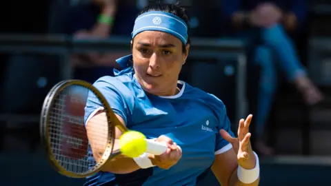 Ons Jabeur hits a forehand