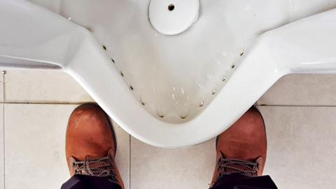 Stock image of a public urinal