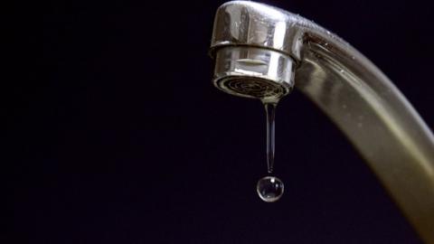 A drop of water dripping from a tag