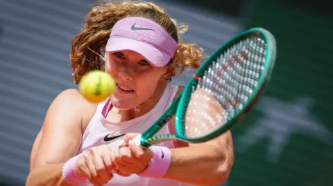 Mirra Andreeva hits a backhand