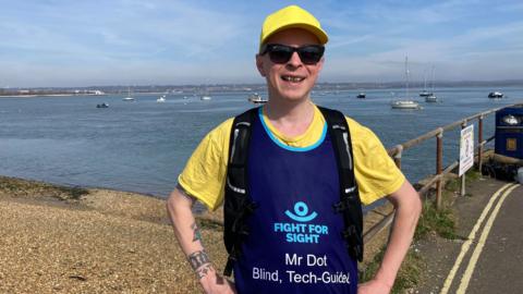 mr dot smiling and wearing running clothing and smart glasses