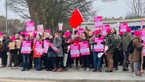 A picket line outside the University of Aberdeen, many with strike placards.