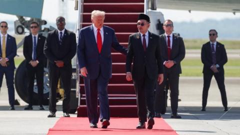 Malaysian Prime Minister Anwar Ibrahim welcomes U.S. President Donald Trump on the first stop of his trip to Asia, at Kuala Lumpur International Airport in Sepang, Malaysia, October 26, 2025