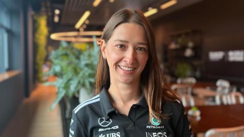 A woman engineer in a black INEOS top 