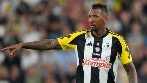 Jerome Boateng points while on the pitch