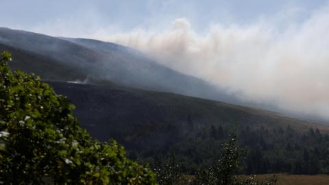 Smoke from a moorland blaze rises near the Dovestone Reservoir.
