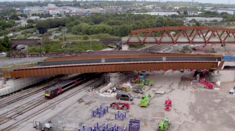 Construction workers on site in Saltley moving the huge bridge into place