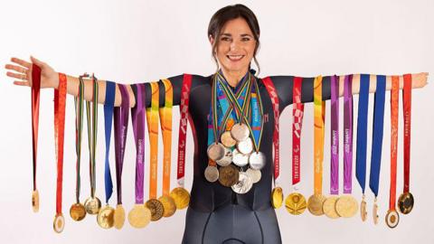 Dame Sarah Storey posing with her Paralympic medals