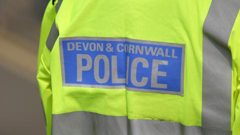 A generic photo shows the back of a Devon and Cornwall Police reflective jacket, with the person wearing it remaining anonymous. Picture taken in Cornwall in 2007.