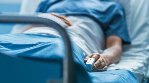 A patient lying in a hospital bed