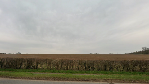 Agricultural land beyond the edge of a road