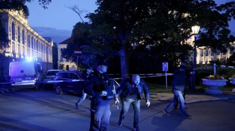 Polish police secure an area at the University of Warsaw campus after an attack with an axe