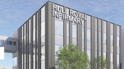 A computer image of the new building. It has grey vertical cladding with glass windows and an aerial walkway attacked to the left side. It has the words Hull Royal Infirmary in large white letters attached to the top of the building. Green trees stand in front of it.