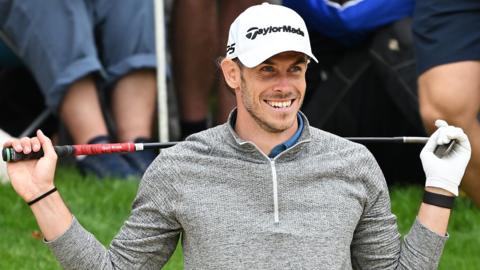 Gareth Bale smiles on the golf course