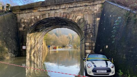 Car under flooded bridge at Bathford
