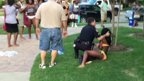 police officer pushes teenage girl to ground