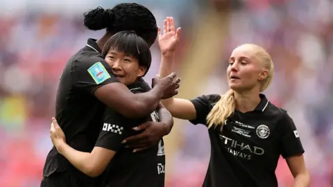 Aoba Fujino celebrates with Man City team-mates