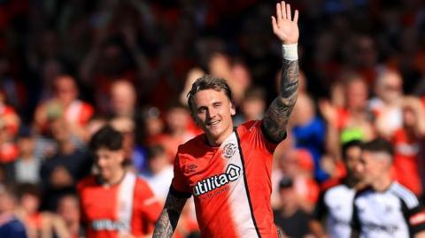 Alfie Doughty waves to Luton Town fans in the crowd at Kenilworth Road