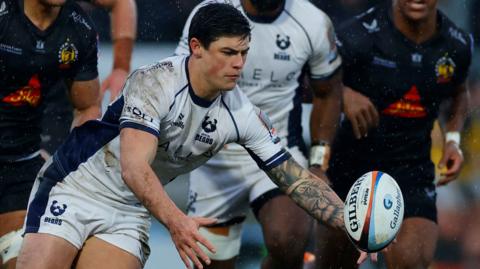 Louis Rees-Zammit attempts to gather the ball