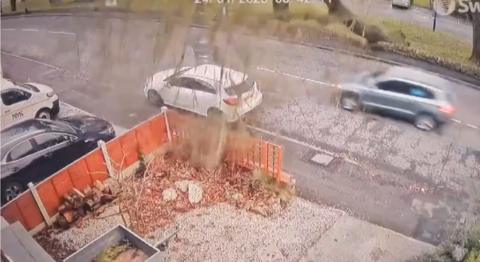 Tree falls over road as car being driven on it