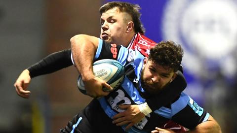 Kirby Myhill of Cardiff is tackled by Steff Evans