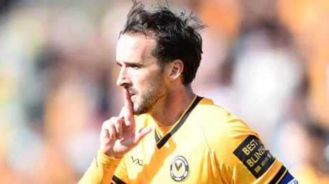 Newport County midfielder Aaron Wildig celebrates scoring a goal