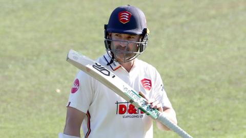 Dean Elgar celebrates scoring a century for Essex