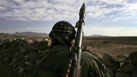 A soldier look out on Afghan terrain