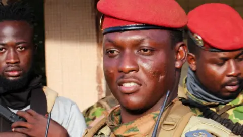 Burkina Faso's new military leader Ibrahim Traore is escorted by soldiers