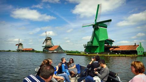 A tourist boat and windmills in the Zaanse Schans