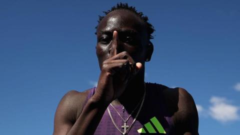 Australian sprinter Gout Gout puts his finger to his lips and makes a '1' sign after his win