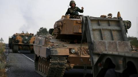 Turkish army vehicles move on a road near the Turkish border town of Ceylanpinar, Sanliurfa province, Turkey, October 18, 2019