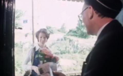 Stationmaster Spud Murphy speaks to a passenger.