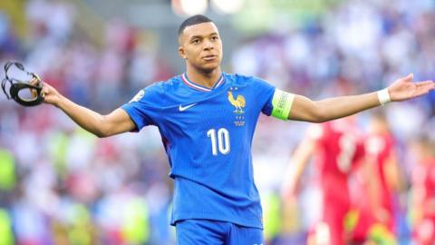 France striker Kylian Mbappe with his arms outstretched