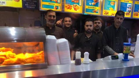 Staff behind the counter at Victoria Fish Bar