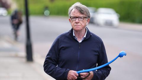Lord Mandelson walking his dog
