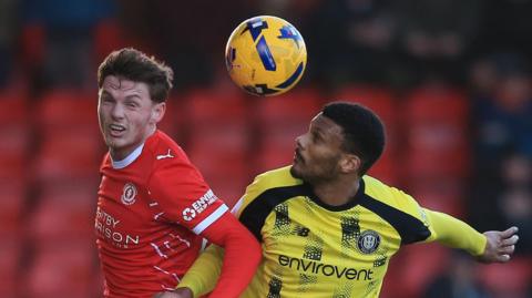 Tommi O'Reilly of Crewe Alexandra (L) vies with Kyle Jameson of Harrogate Town.