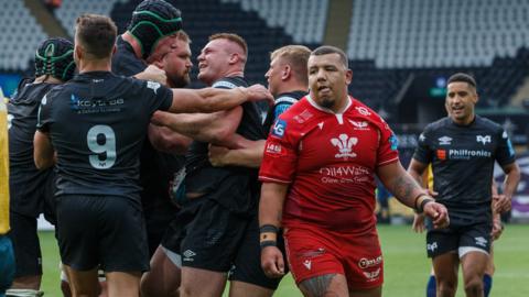 Ospreys celebrate scoring a try against Scarlets