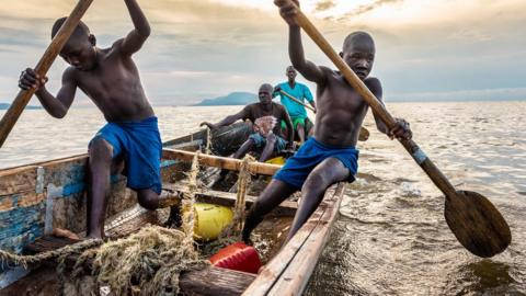 Kenyan boys and fishermen on Lake Victoria