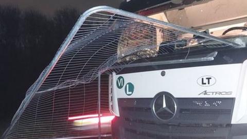 A lorry with a metal fence on it
