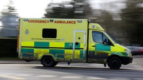 East of England Ambulance driving down a road