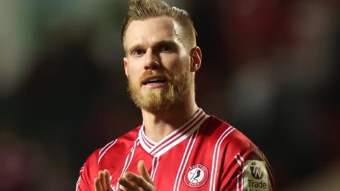 Thomas Kalas applauds the fans while playing for Bristol City